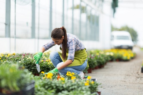 A gardener reviewing a service concern in a neat outdoor setting