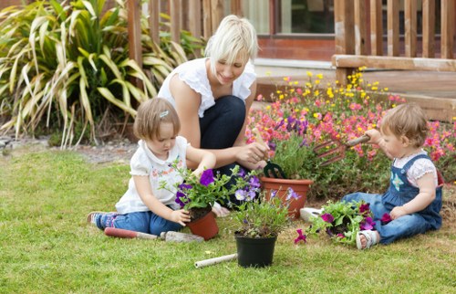 Skilled gardeners shaping hedges and planting in Dartmouth Park
